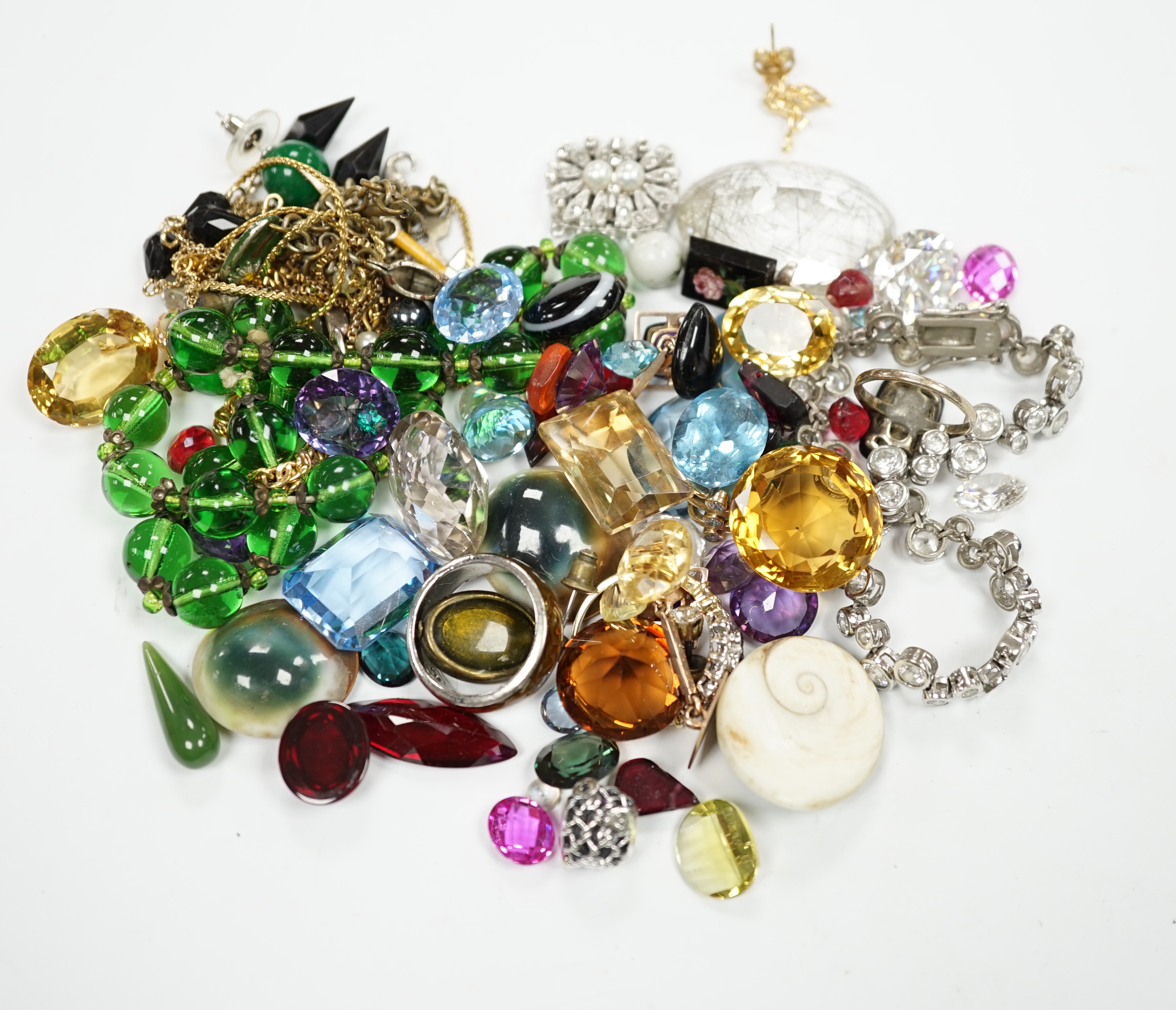 Assorted unmounted cut gemstones including rutilated quartz and other costume jewellery including 925 and paste set tennis bracelet and a 9ct gold ring, etc.